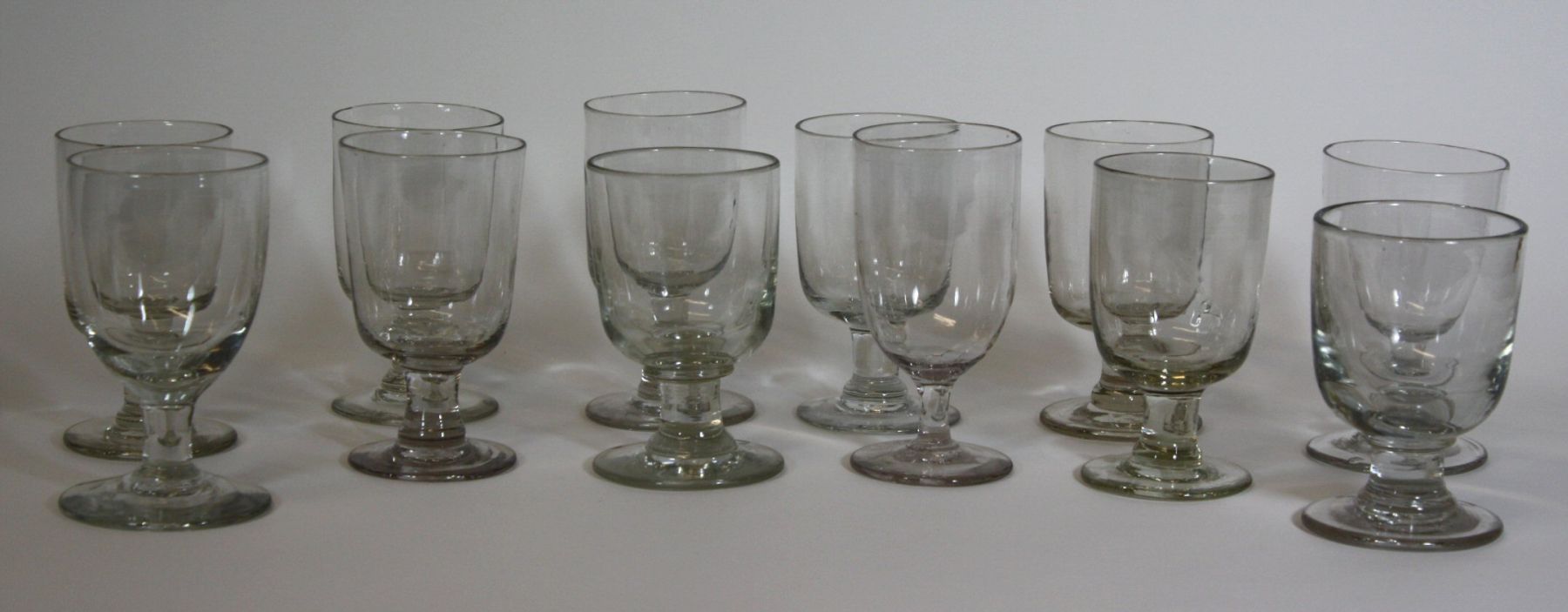 ASSEMBLED SET OF TWELVE GLASS RUMMERS