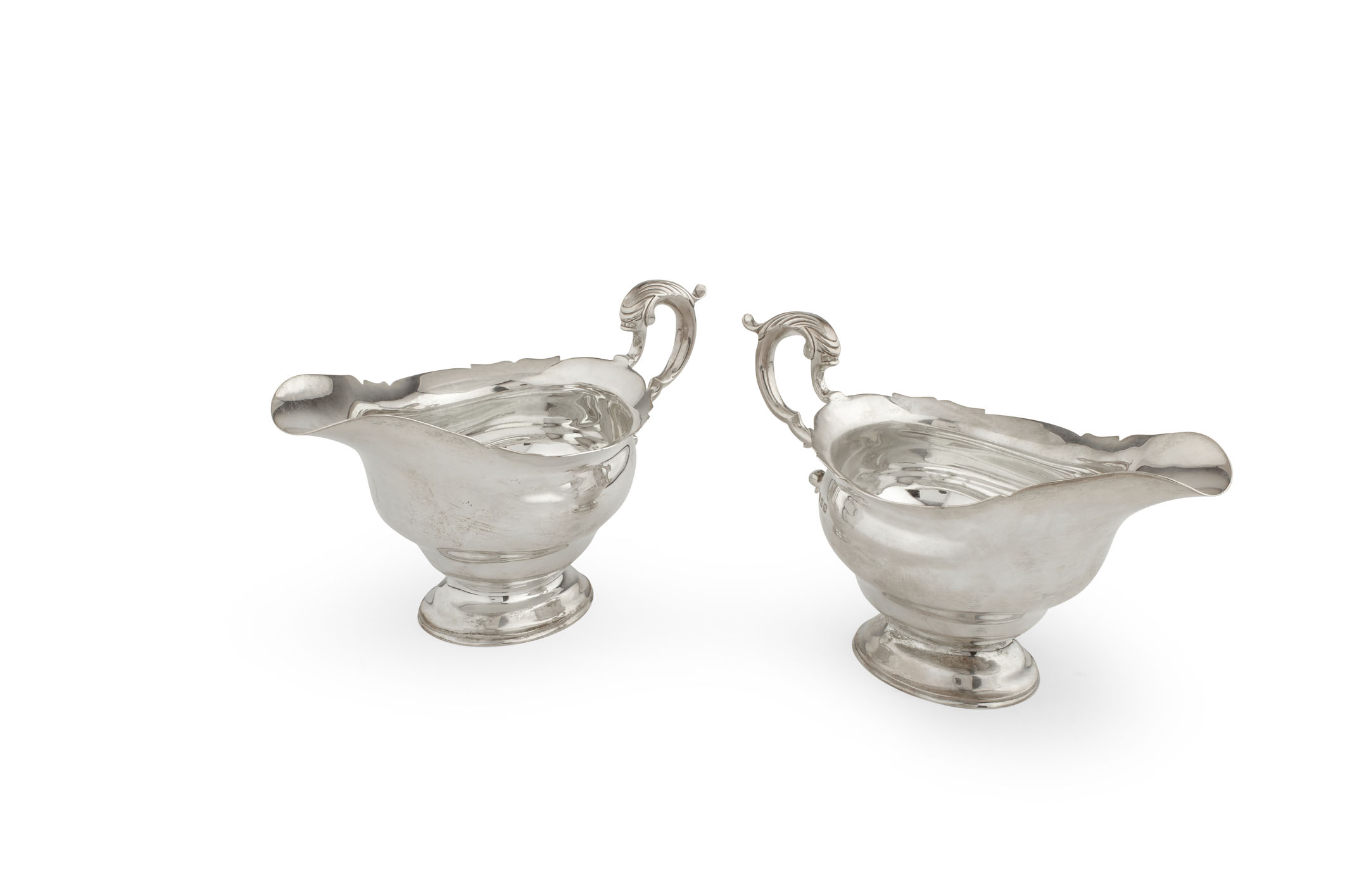 A cased pair of modern sauce boats