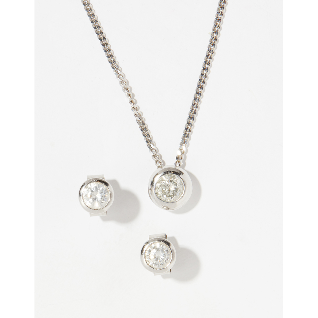 An 18ct gold diamond set pendant and matching ear studs