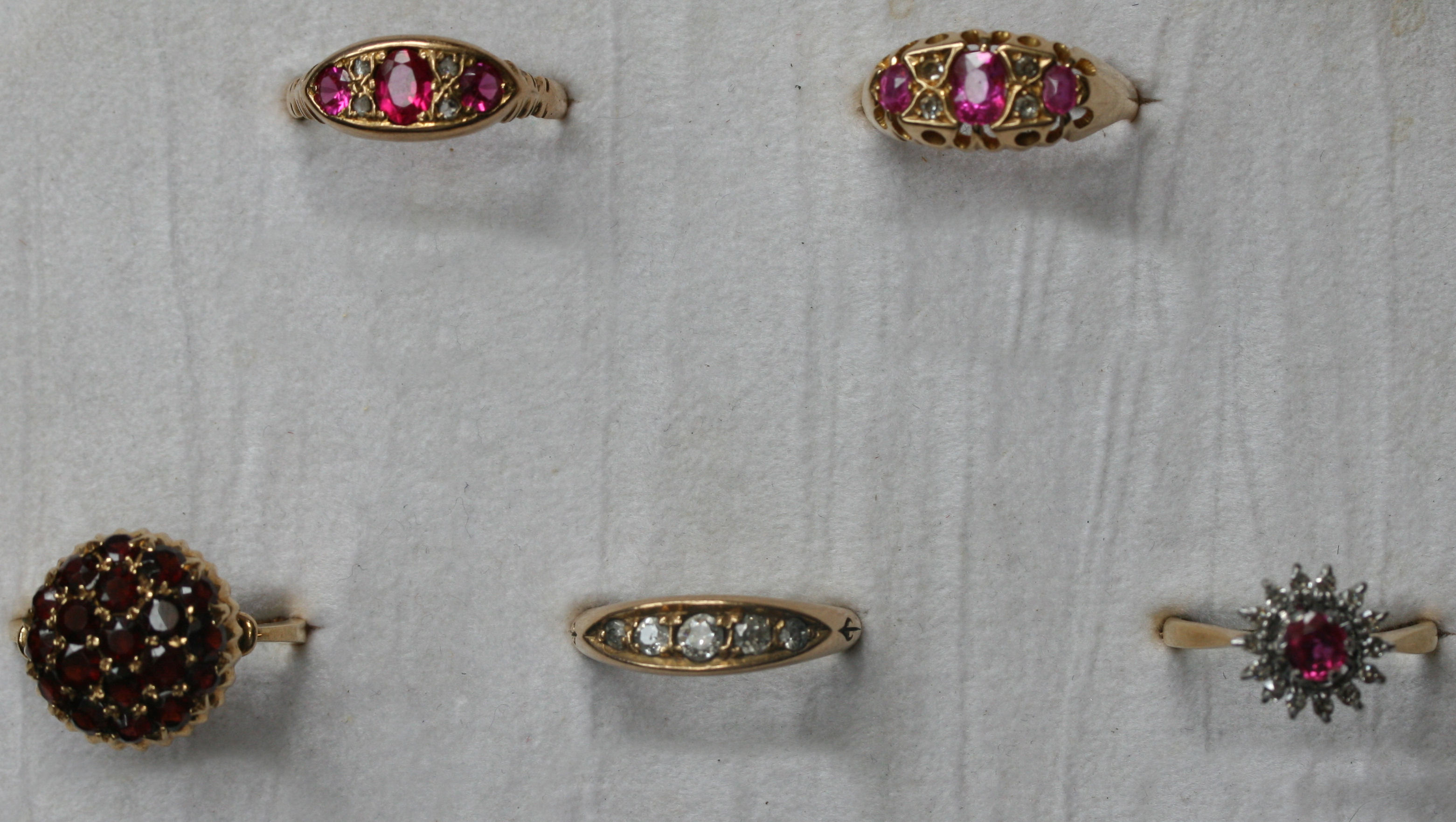 A group of five diamond, ruby and garnet set gold rings