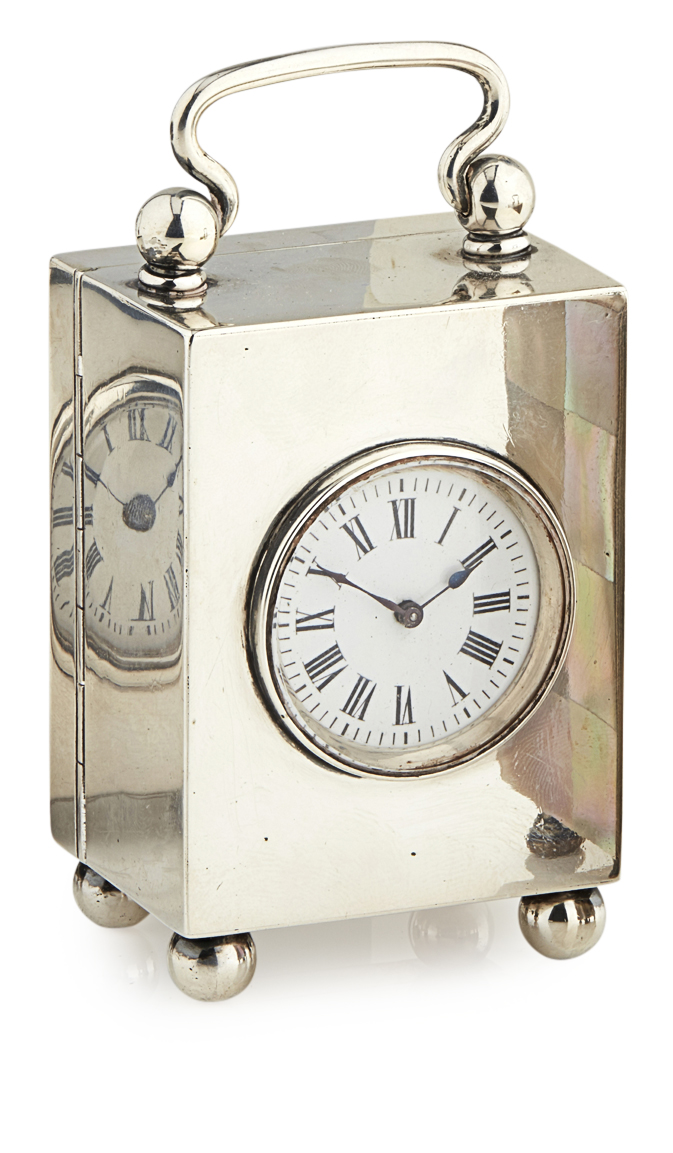 A small late Victorian silver cased dressing table clock