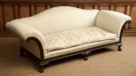 An upholstered and mahogany settee