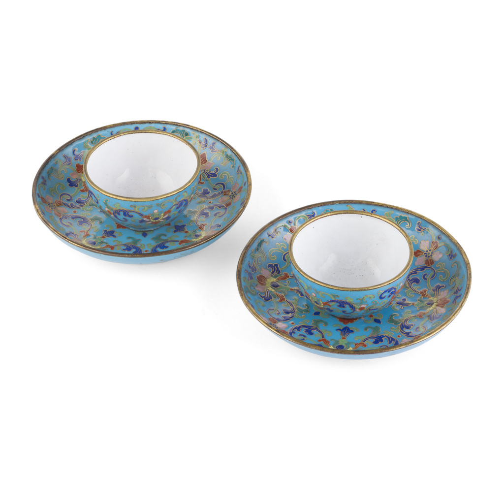 PAIR OF PAINTED ENAMEL CUPS AND SAUCERS