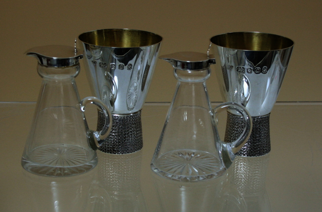 A pair of silver mounted glass noggins