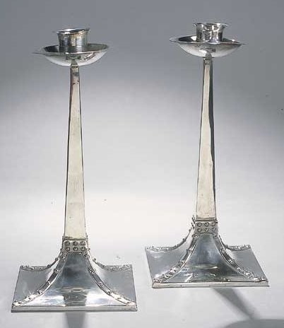 A pair of Arts and Crafts silver candlesticks