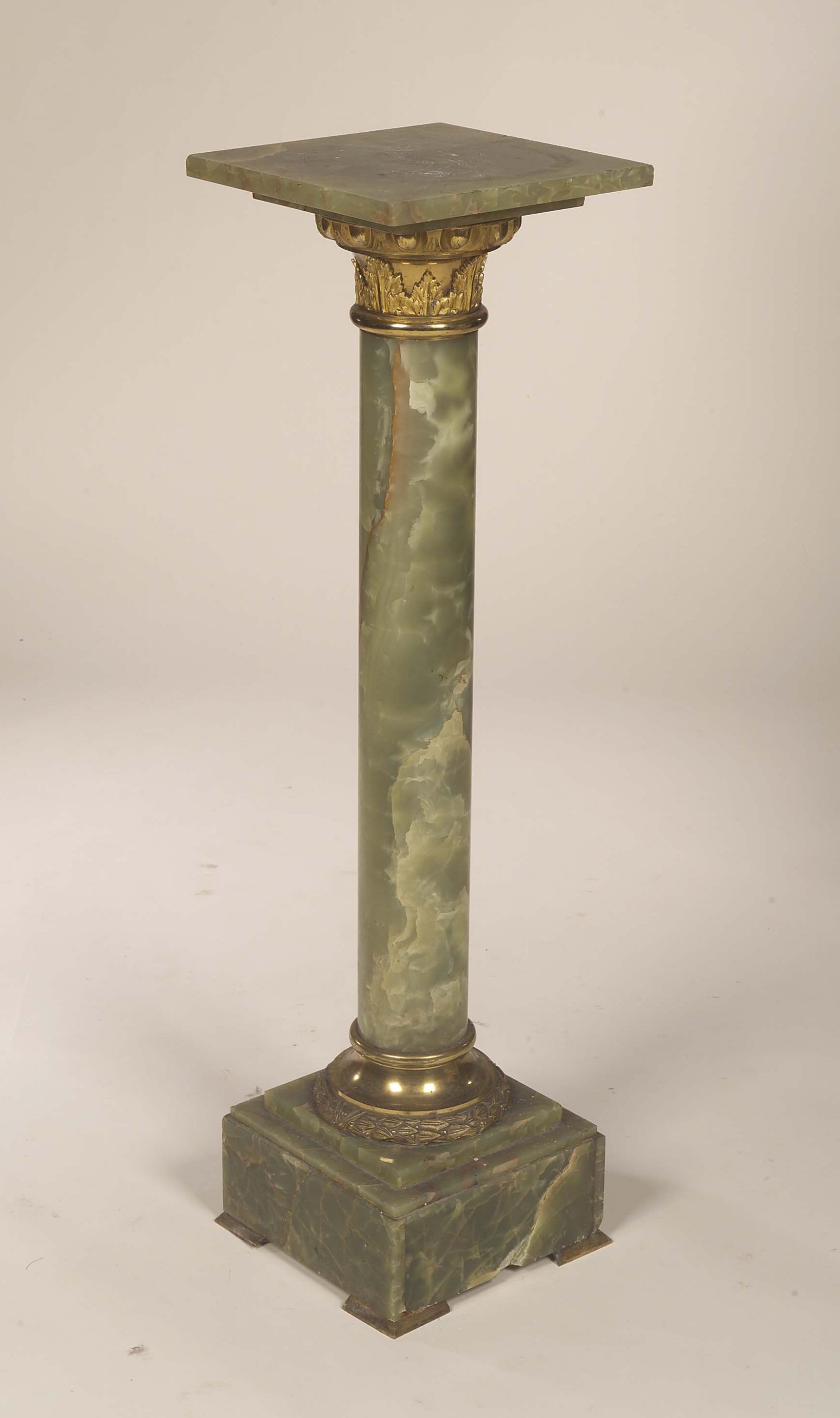 A gilt metal mounted onyx pedestal,
