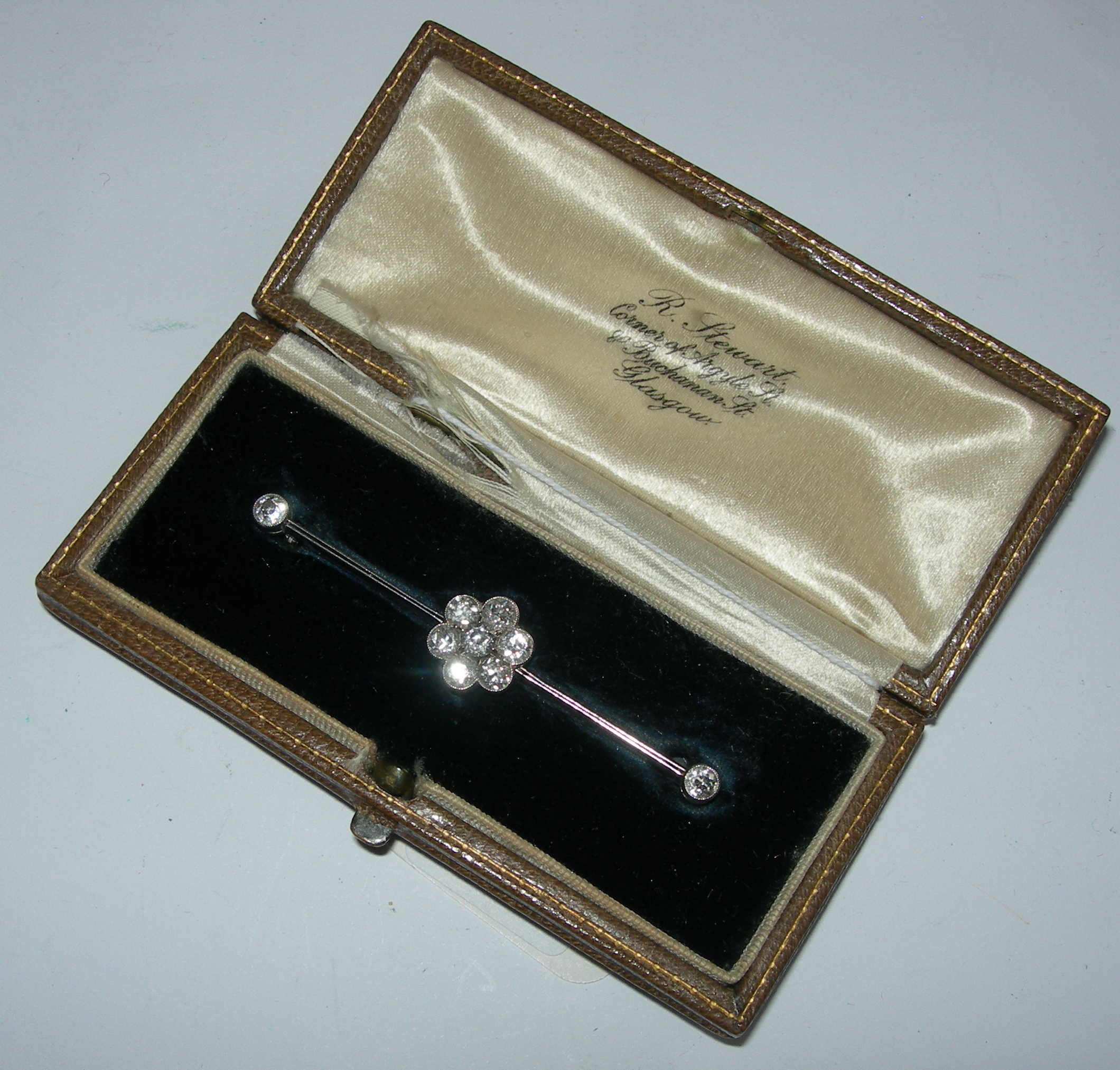 A diamond set bar brooch,