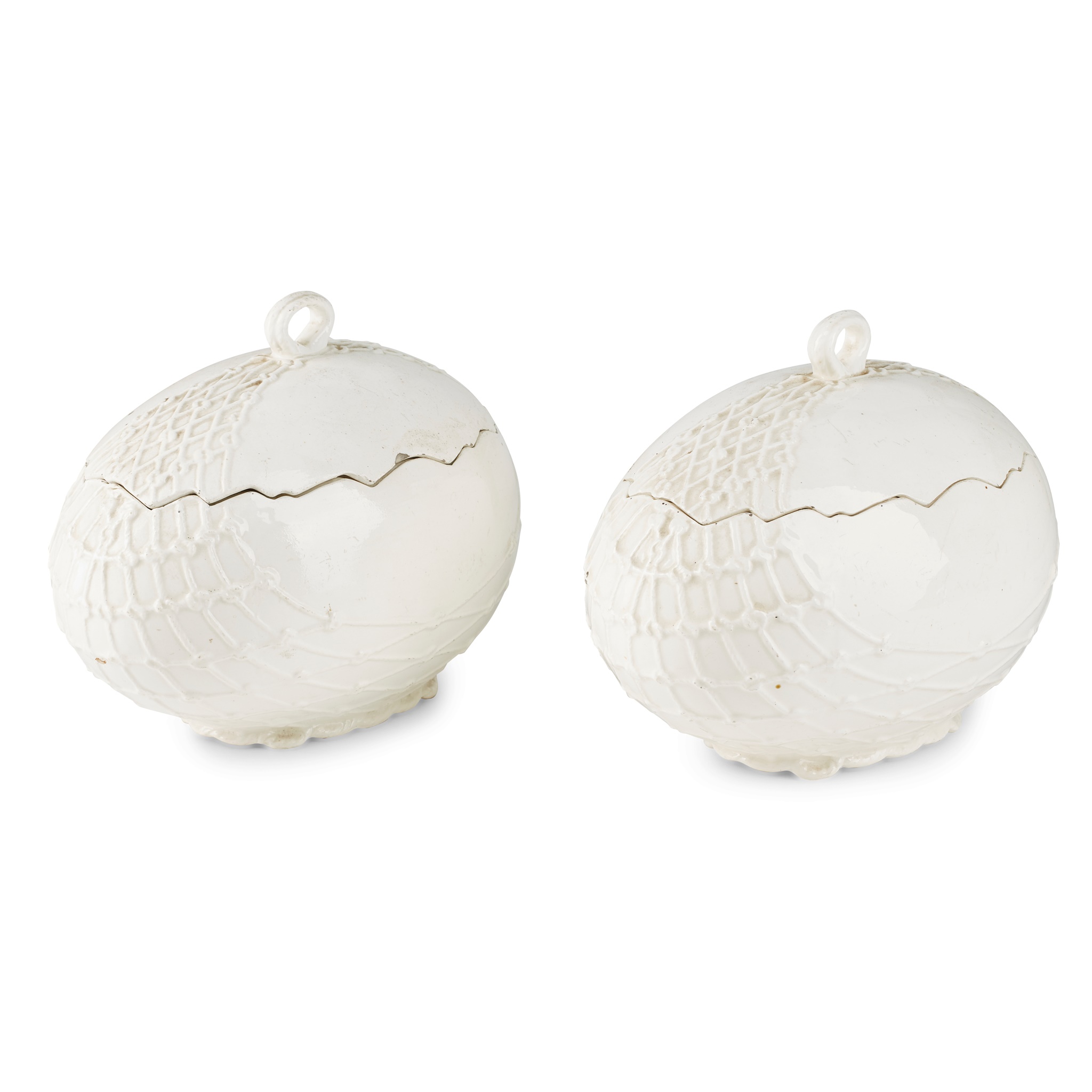 PAIR OF CONTINENTAL WHITE GLAZED POTTERY 'EGG' TUREENS