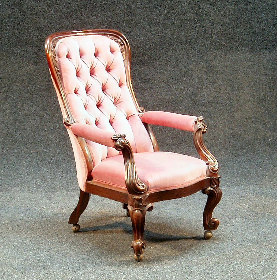 A Victorian rosewood button back armchair,