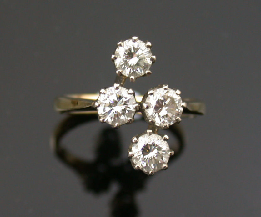 An 18ct gold mounted diamond four stone ring,