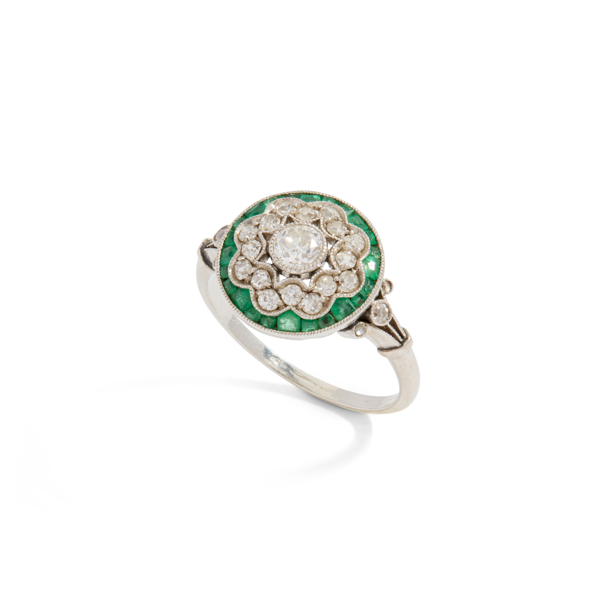 An early 20th century diamond and emerald ring