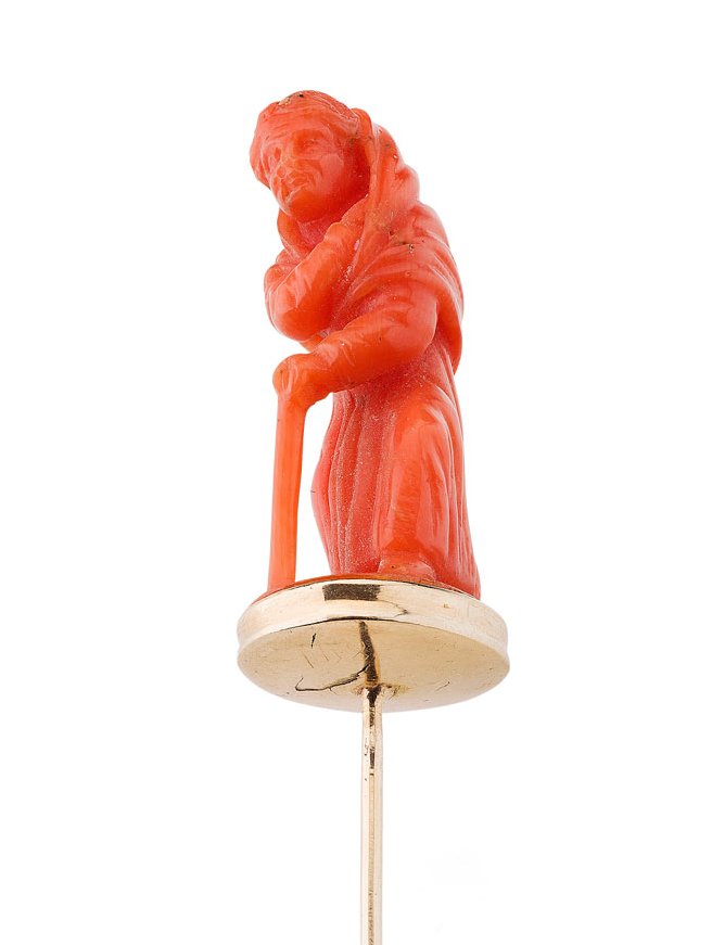 An early 19th century carved coral set stick pin