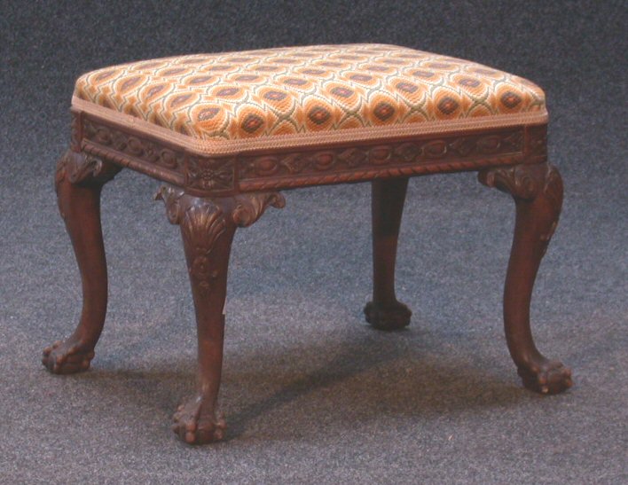 An upholstered oak stool,
