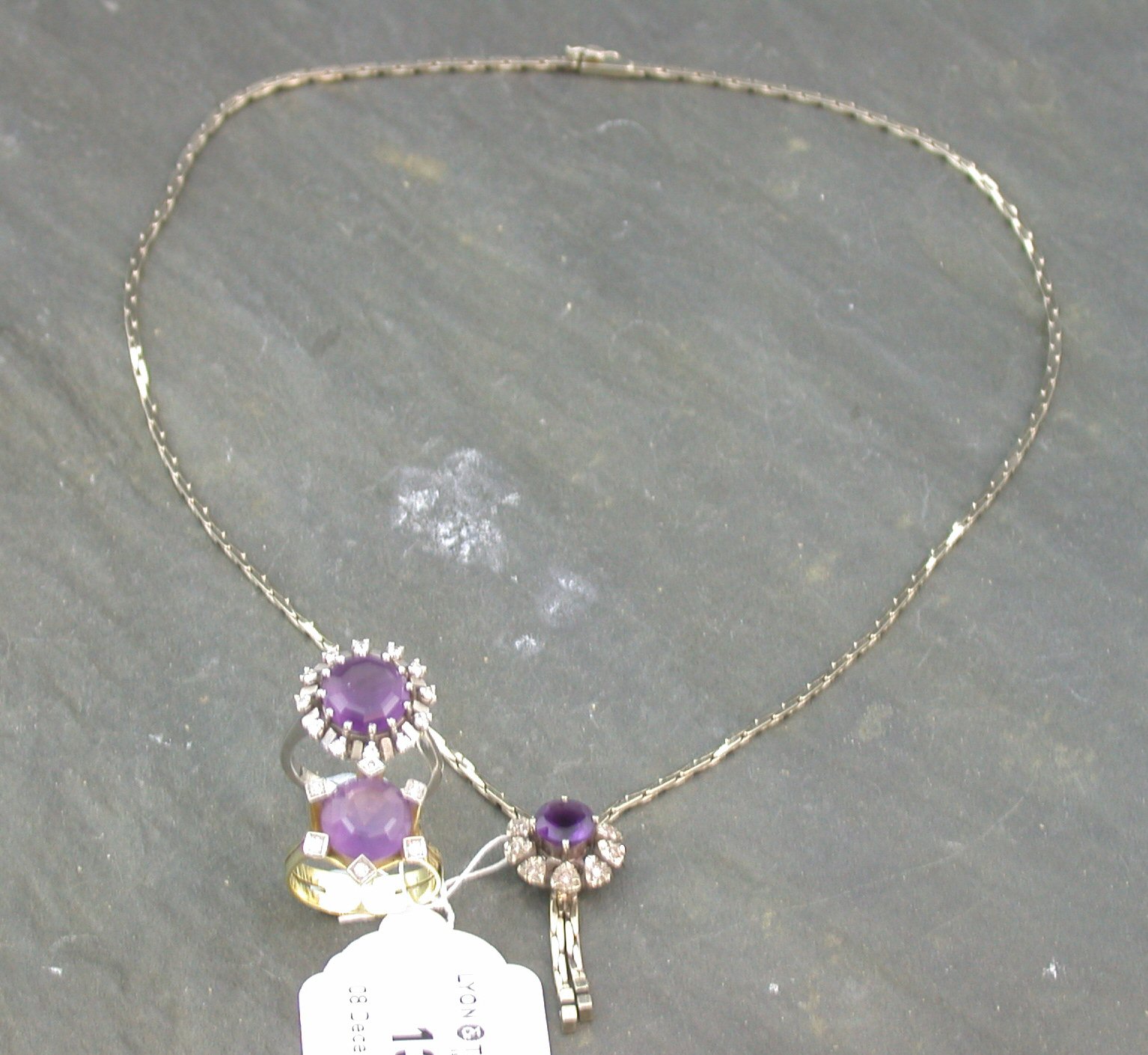 Three amethyst and diamond set items,