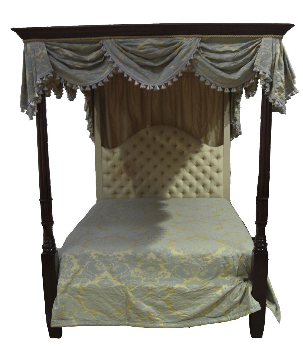 A mahogany four poster bed with drapes