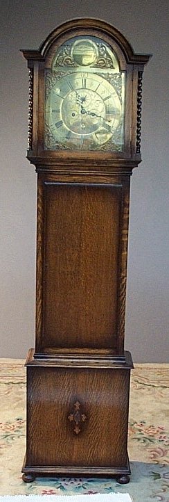 An oak longcase clock