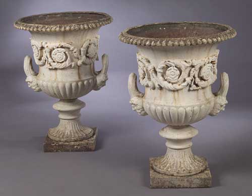 A pair of cast iron garden urns