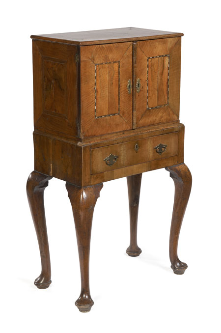 An early 18th century walnut cabinet on stand