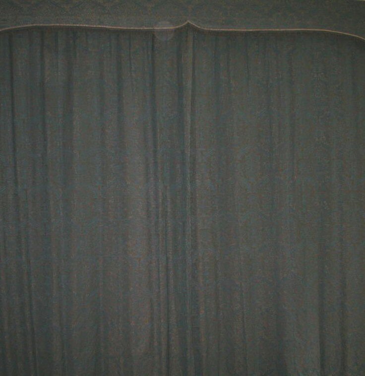 A large pair of blue damask curtains and pelmet