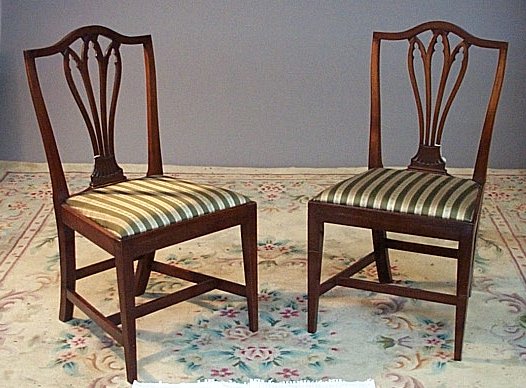 A set of five mahogany Hepplewhite style dining chairs