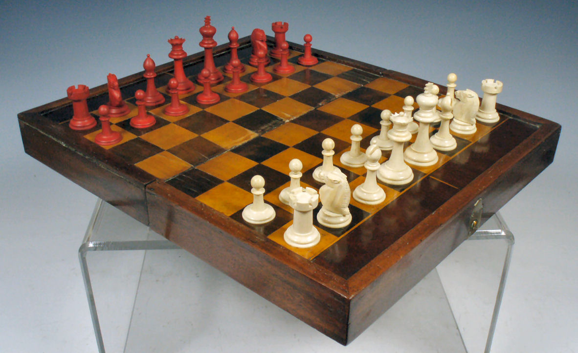 A late 19th century laburnum and fruitwood chess and backgammon board