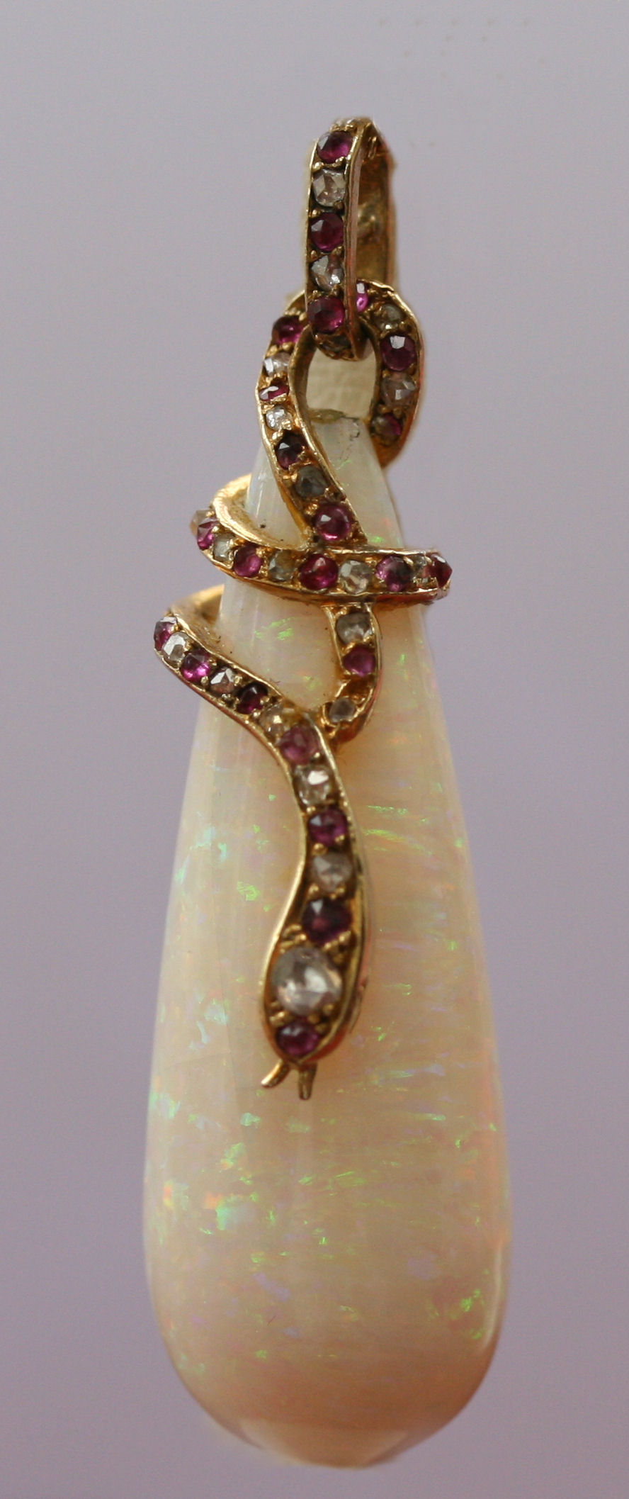 An 18ct gold mounted opal and multi-gem set pendant with chain