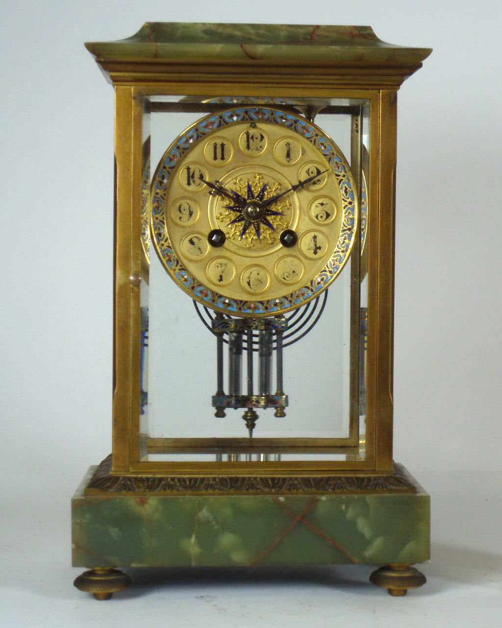 A late 19th century French four glass gilt metal and onyx mantel clock