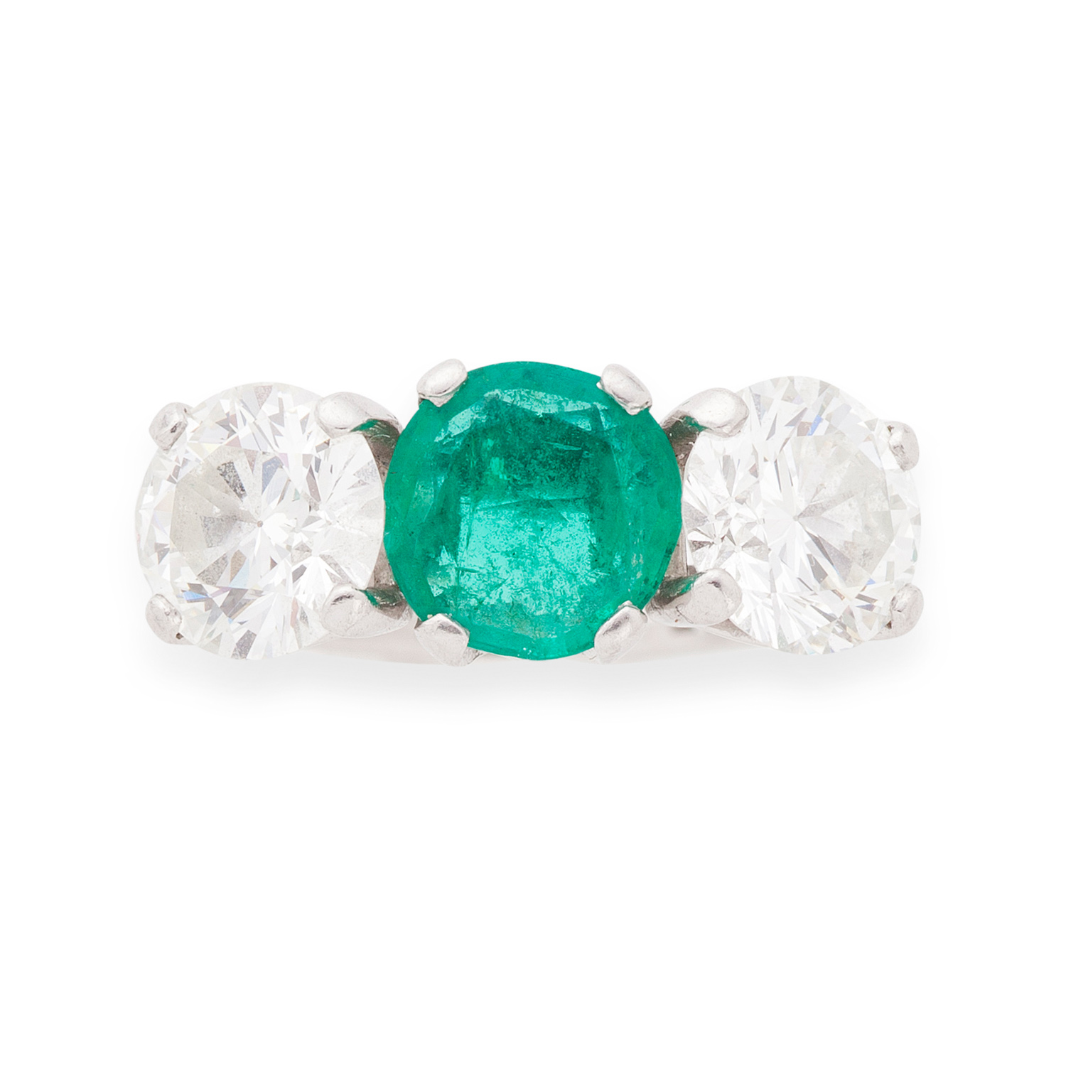 A platinum mounted emerald and diamond set three-stone ring