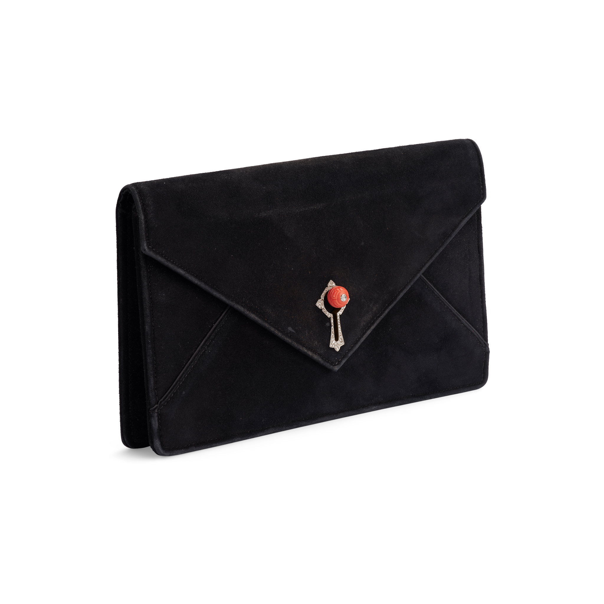 Cartier: A black suede handbag with a coral and diamond clasp