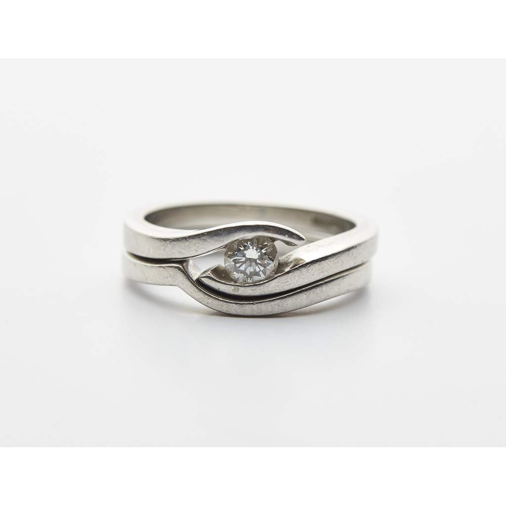 A contemporary single stone diamond set ring