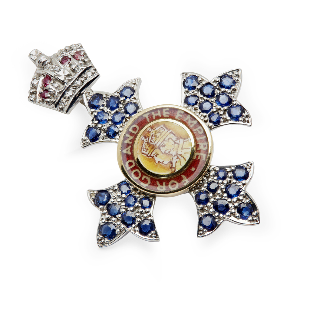 An 18ct white gold and gem set MBE lady's brooch