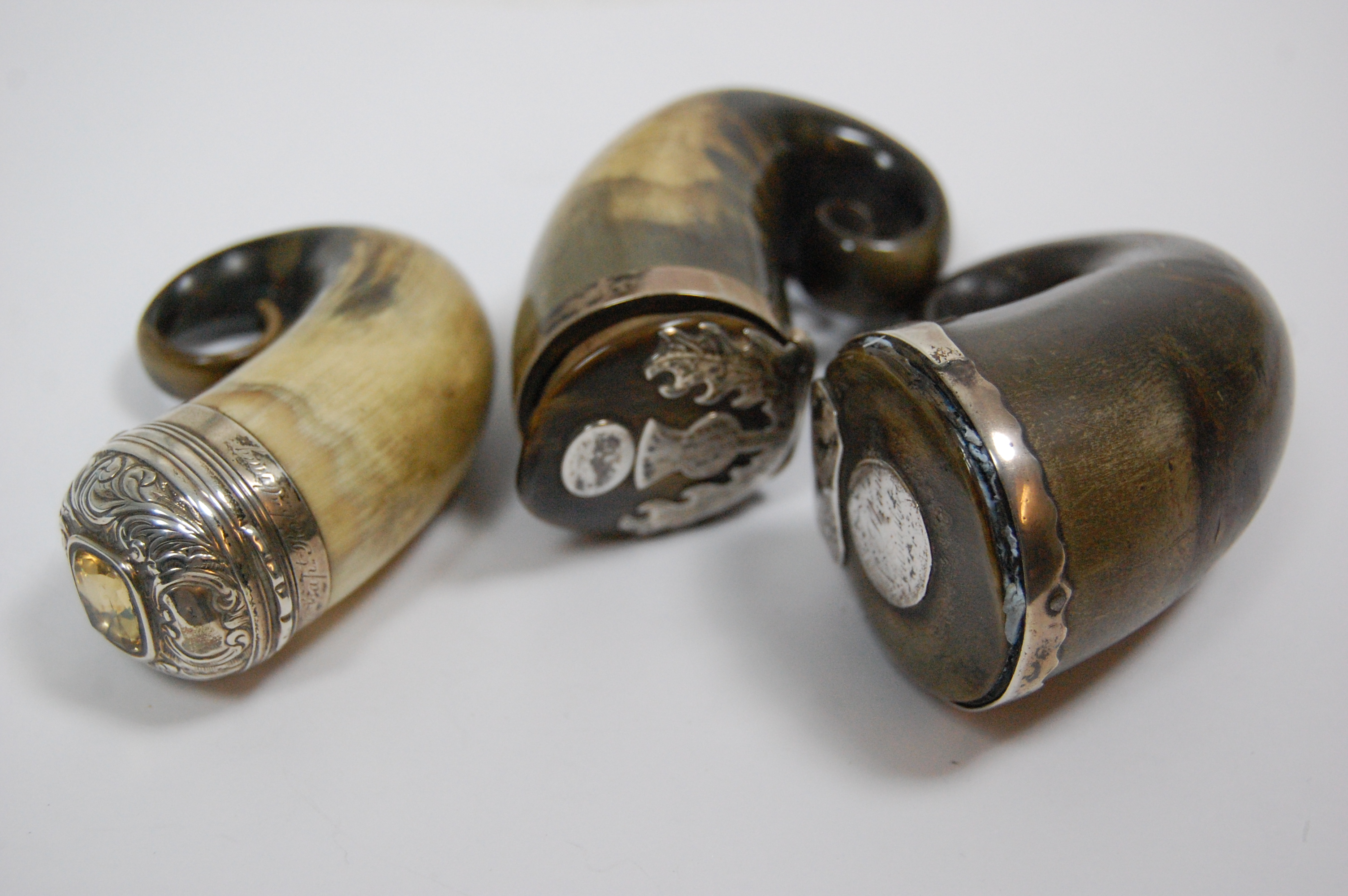 A collection of three curly horned snuff mulls