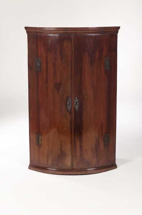 A George III mahogany bow front corner cabinet,