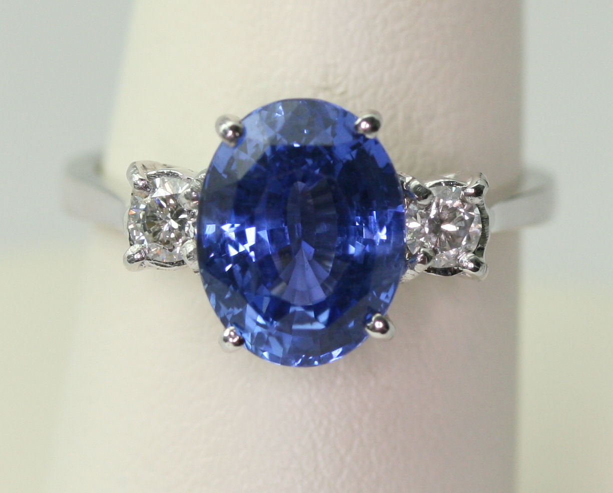 An 18ct white gold mounted sapphire and diamond set three-stone ring