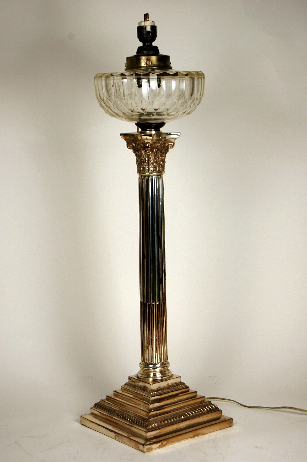 A Victorian silver plated Corinthian column oil lamp