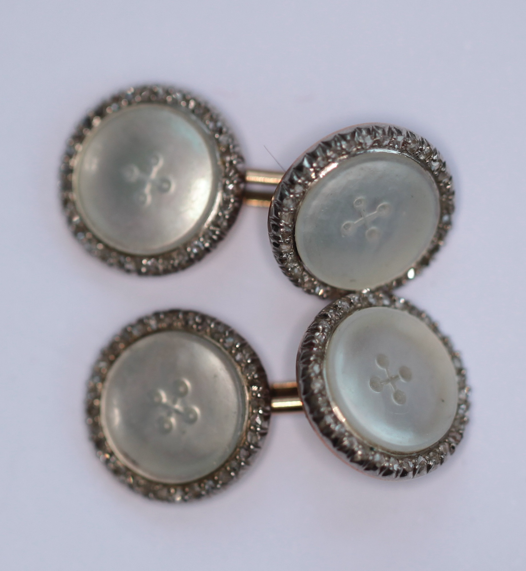 A pair of early 20th century mother-of-pearl and diamond set cufflinks