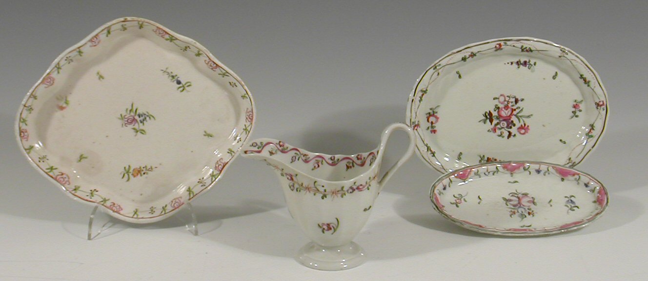 A Newhall fluted helmet shaped milk jug and three stands,