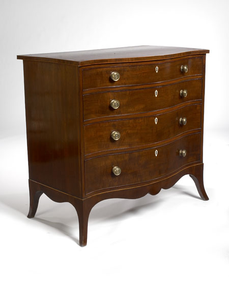 A late George III period mahogany serpentine chest
