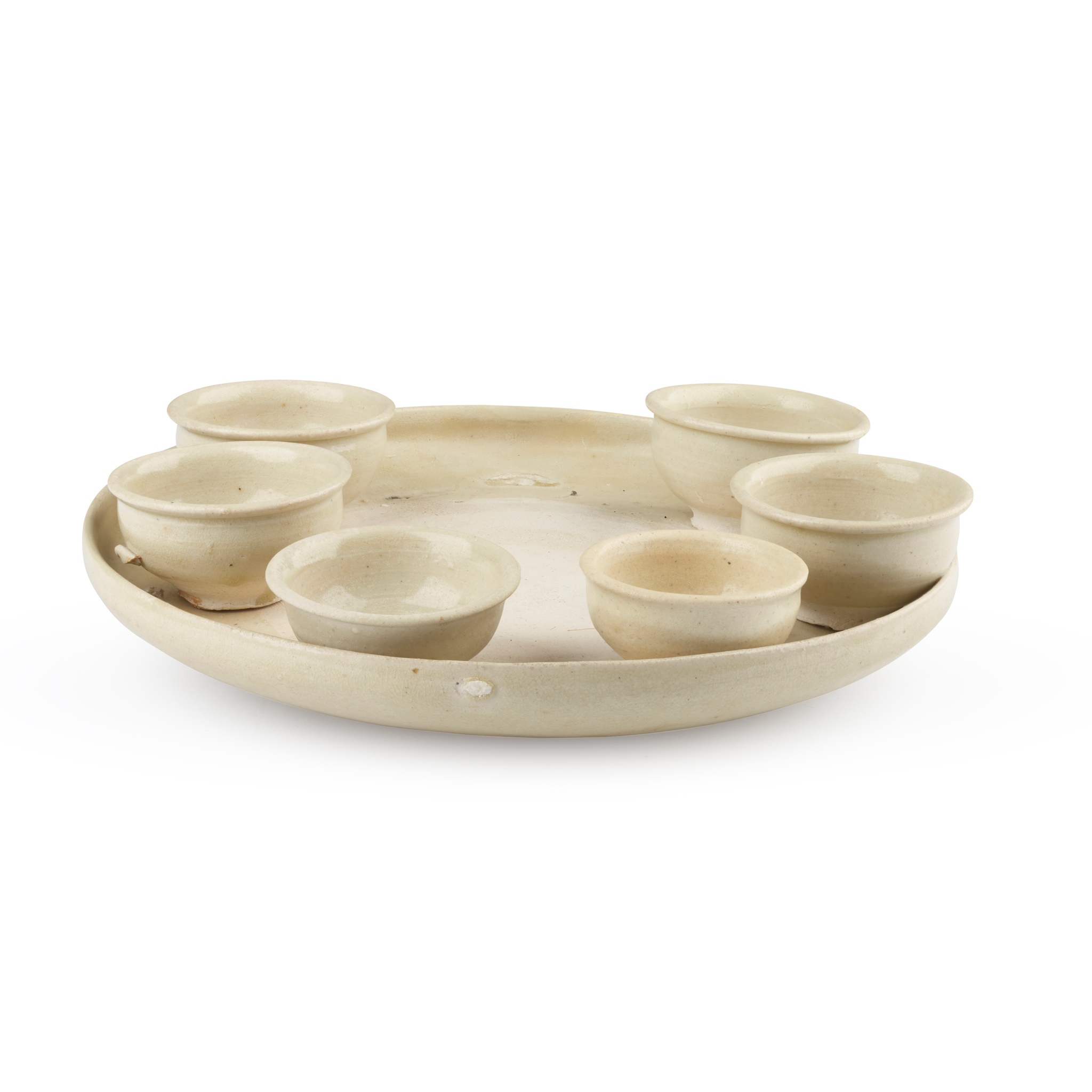 WHITE-GLAZED POTTERY CIRCULAR TRAY WITH SIX CUPS