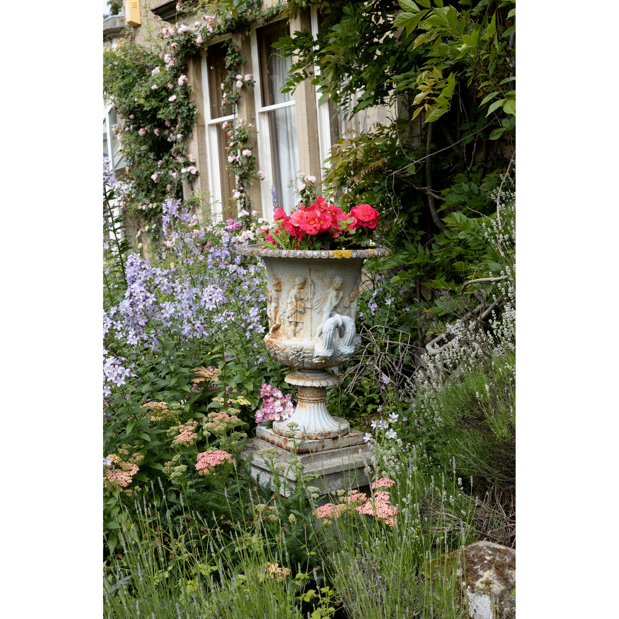 A PAIR OF CAST IRON GARDEN URNS