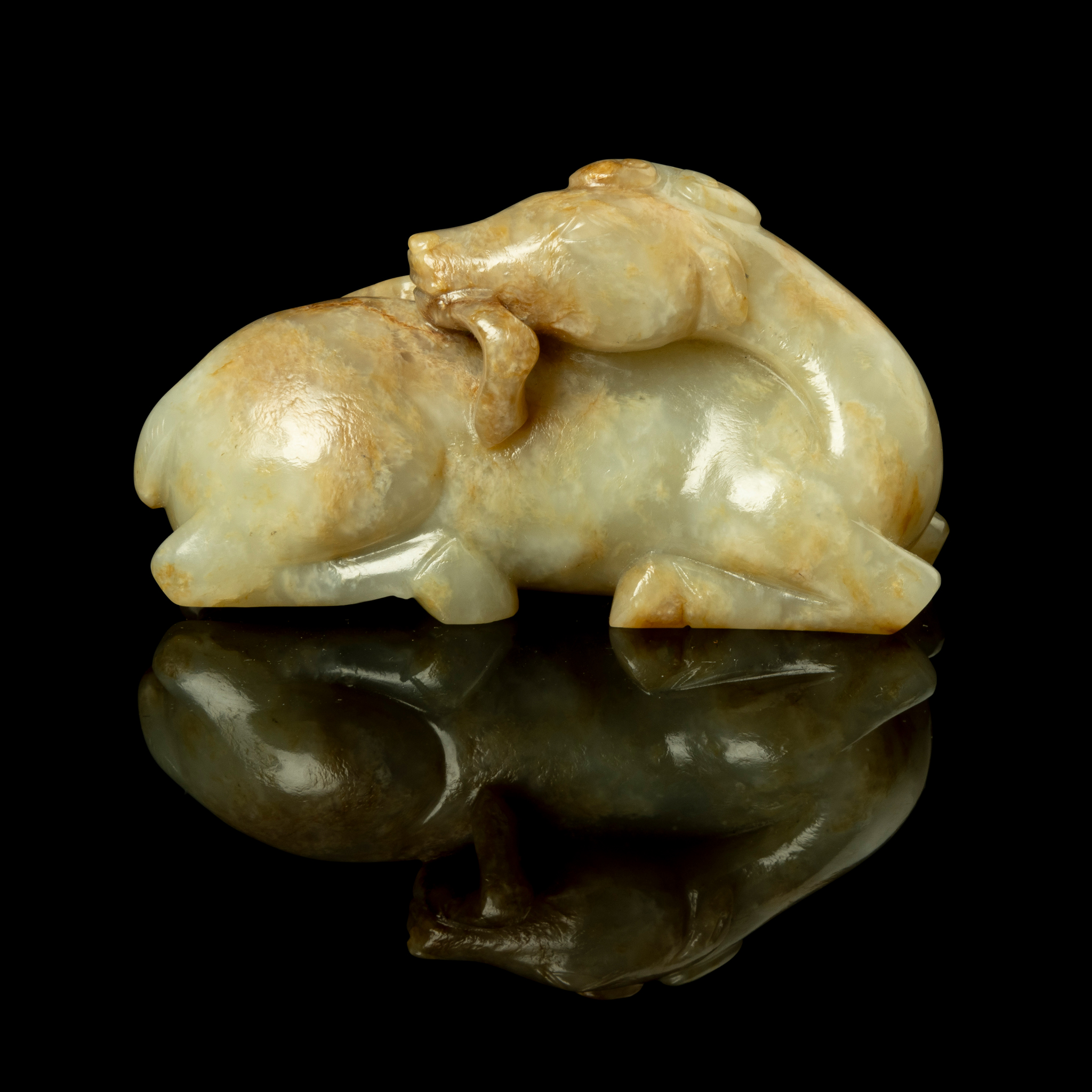 CHINESE WHITE JADE WITH RUSSET INCLUSIONS CARVING OF A DEER WITH RUYI
