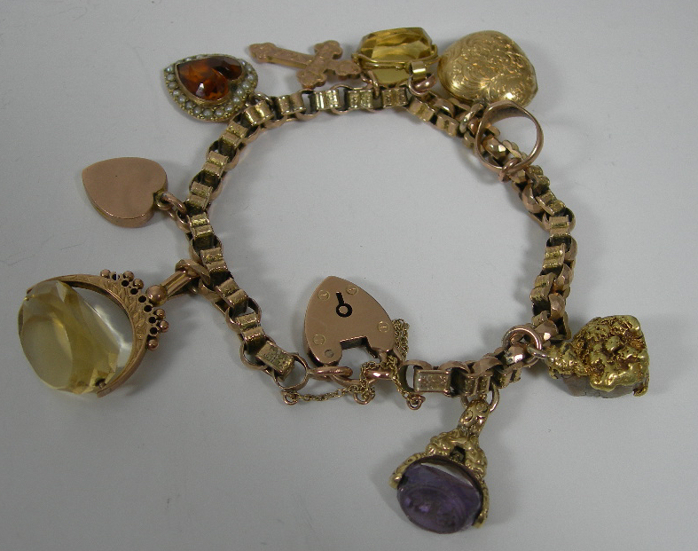A late Victorian 9ct gold charm bracelet,