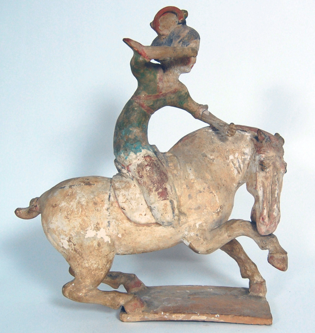 CHINESE EARTHENWARE PAINTED FIGURE OF A FEMALE POLO PLAYER MOUNTED ON A REARING HORSE