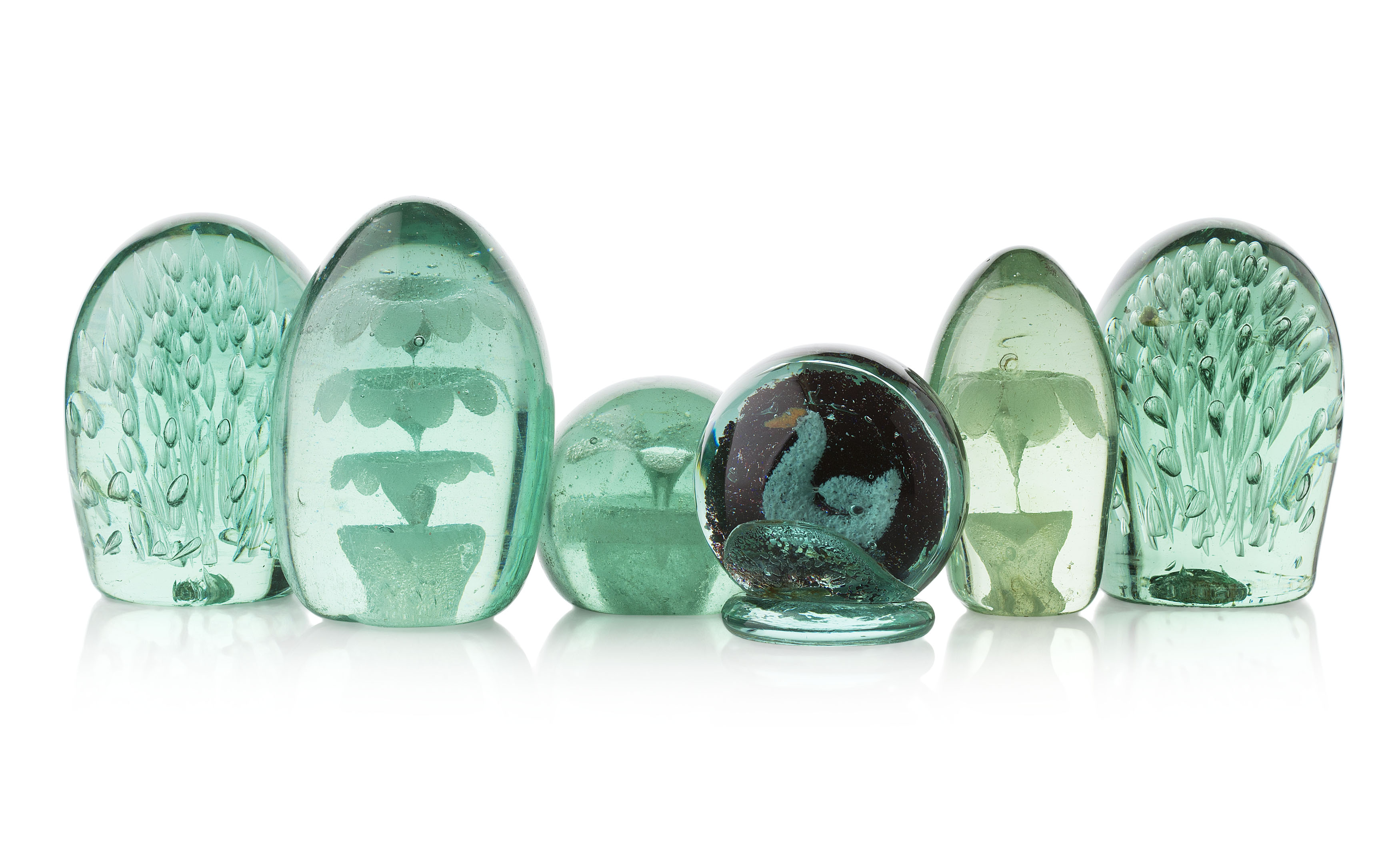 GROUP OF GREEN GLASS DUMP PAPERWEIGHTS