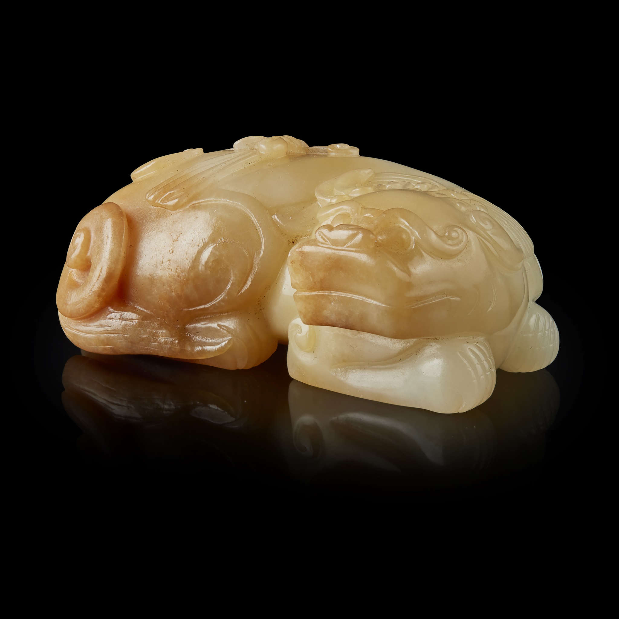 WHITE JADE WITH YELLOW SKIN CARVING OF A BUDDHIST LION