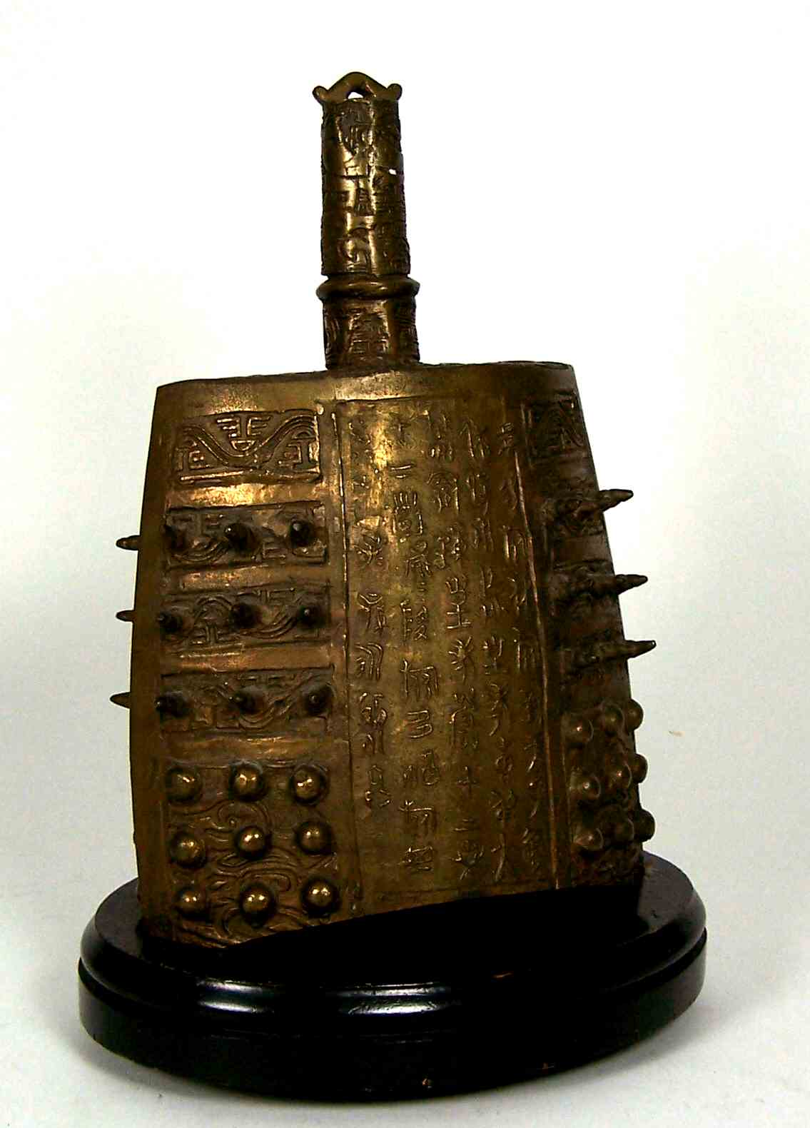 A Burmese bronze temple bell on stand