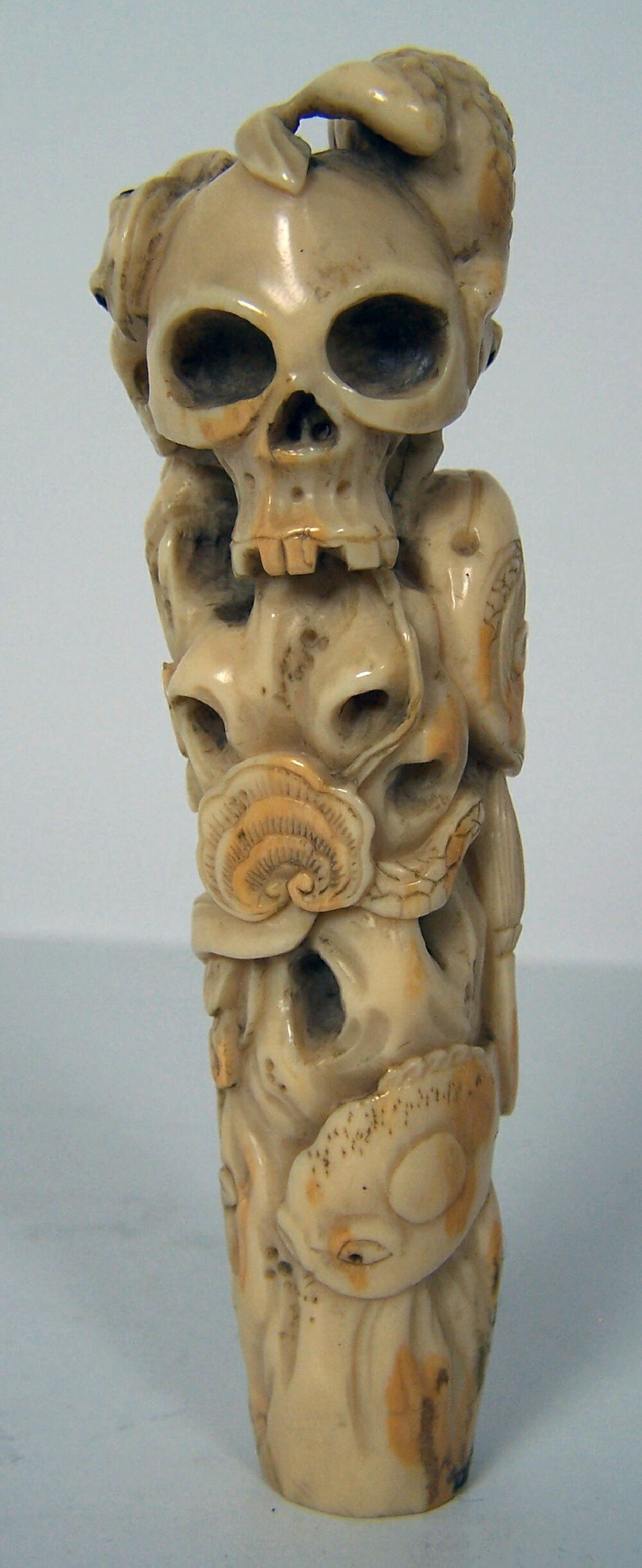 A Eastern carved ivory stick handle