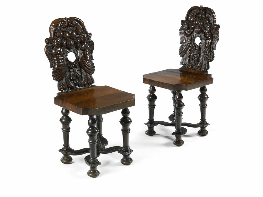A pair of 17th century carved walnut hall chairs In the Baroque taste