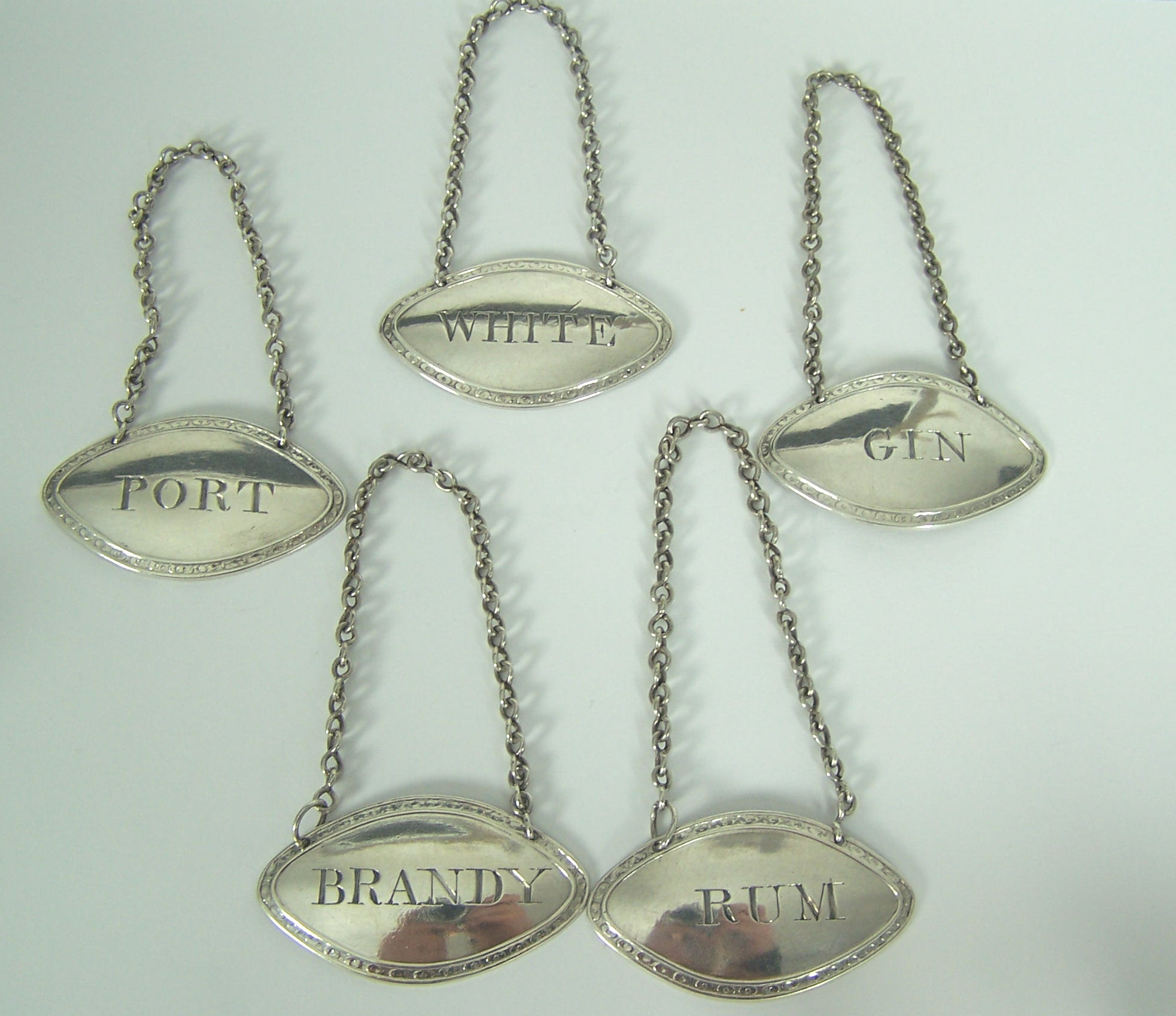 A matched set of five George III spirit labels,