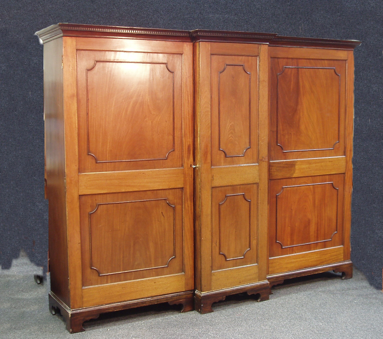 A George III mahogany breakfront wardrobe